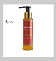 Amber pump bottle of Magic luxury body oil with a gold cap and a red label.
