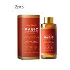 Two red and gold boxes and bottles of Magic luxury body oil with gold caps.