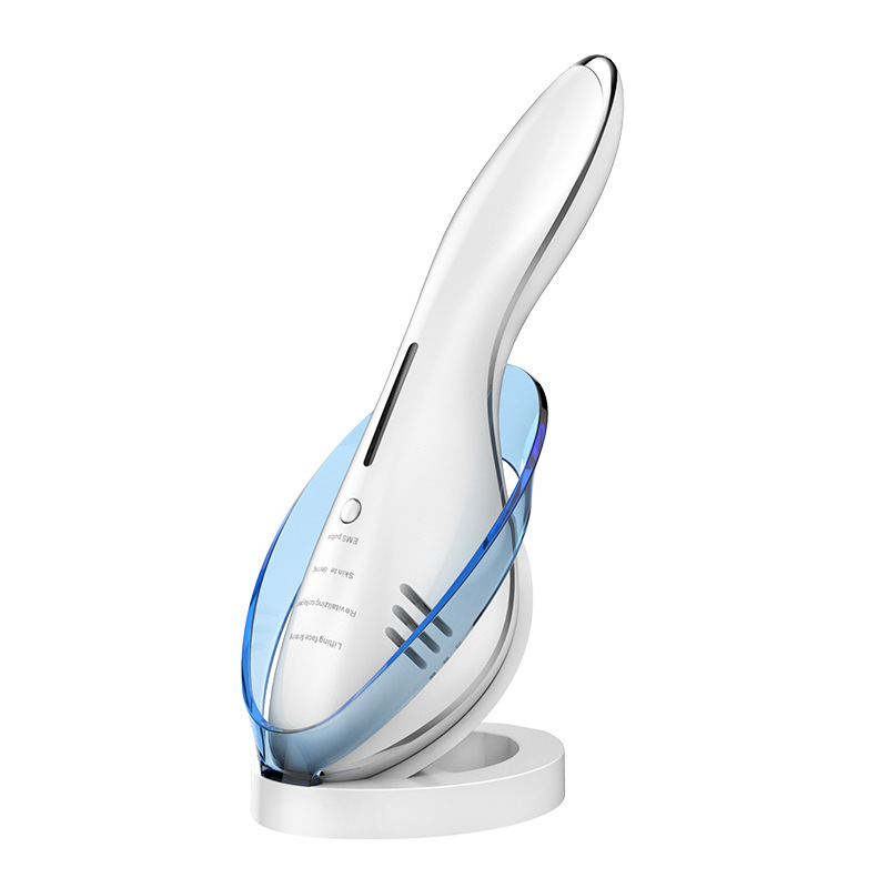 A white, ergonomic facial massager rests in a matching white base with a transparent blue cradle.