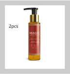 Two bottles of amber-colored Magic luxury body oil with gold caps and black pump dispensers.
